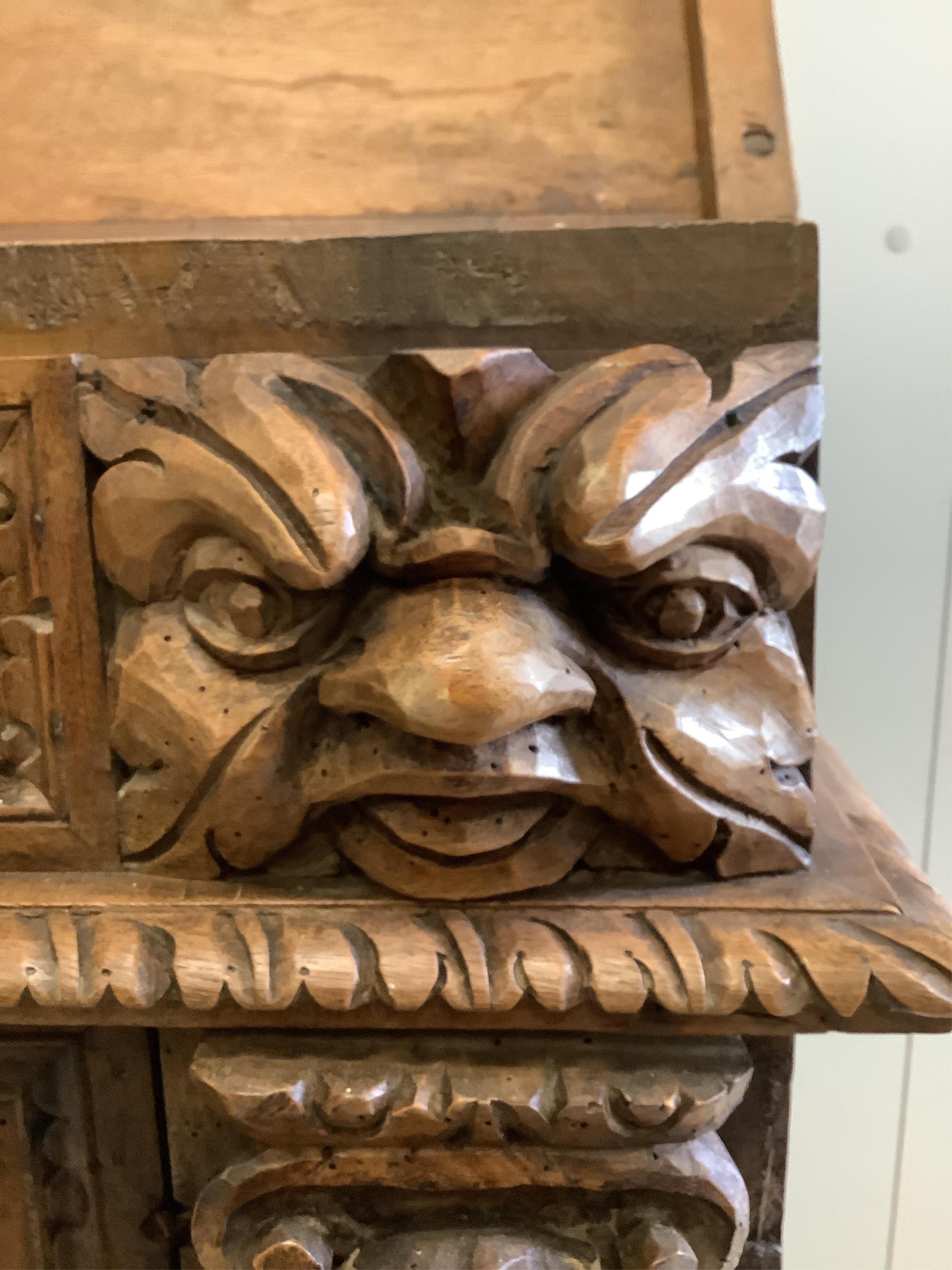 An 18th century style Continental carved walnut prie dieu cabinet, width 72cm, depth 49cm, height 90cm. Condition - poor to fair